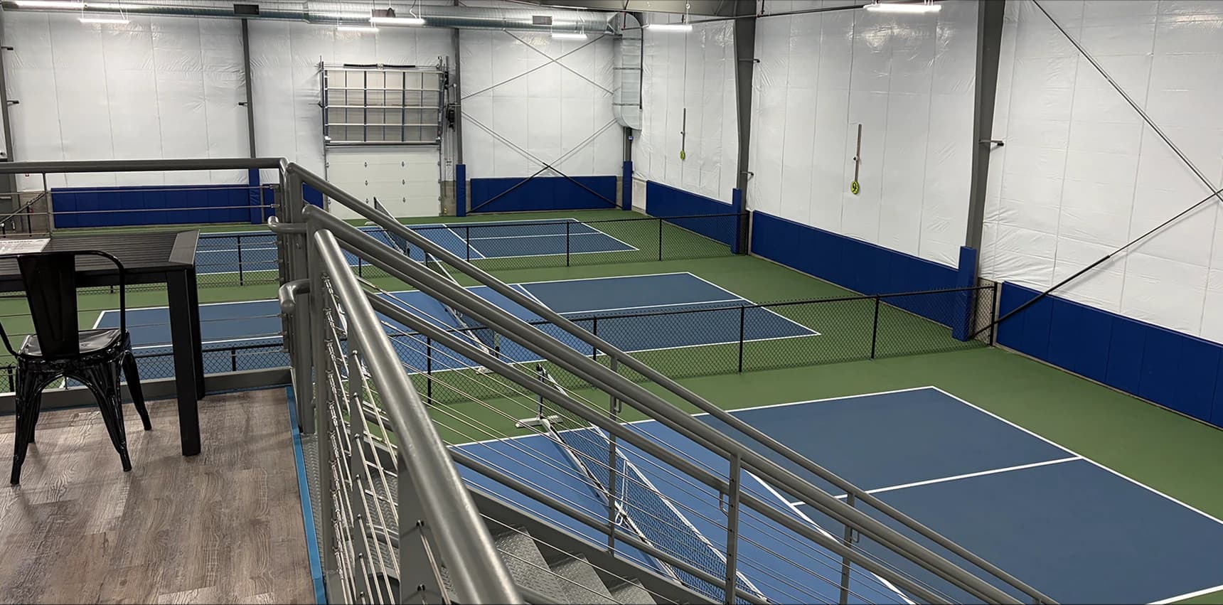 In A Pickle indoor pickleball courts viewed from the mezzanine