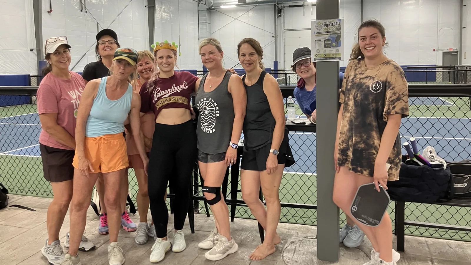 A group of players posing courtside with paddles after a session